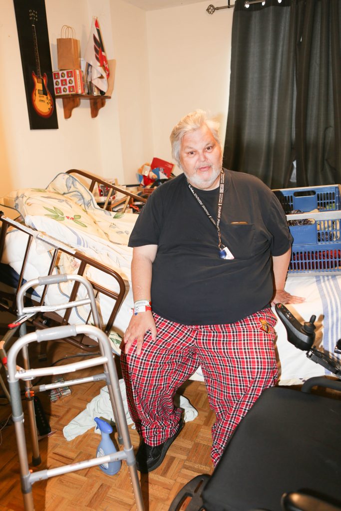 Alan sitting on bed.