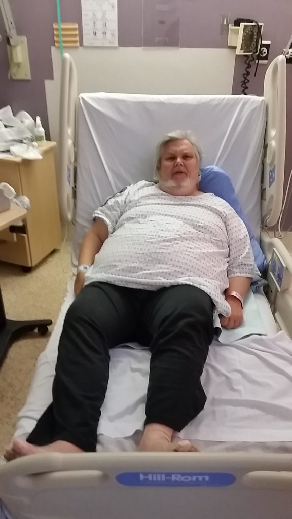 Alan Russell lying in hospital bed