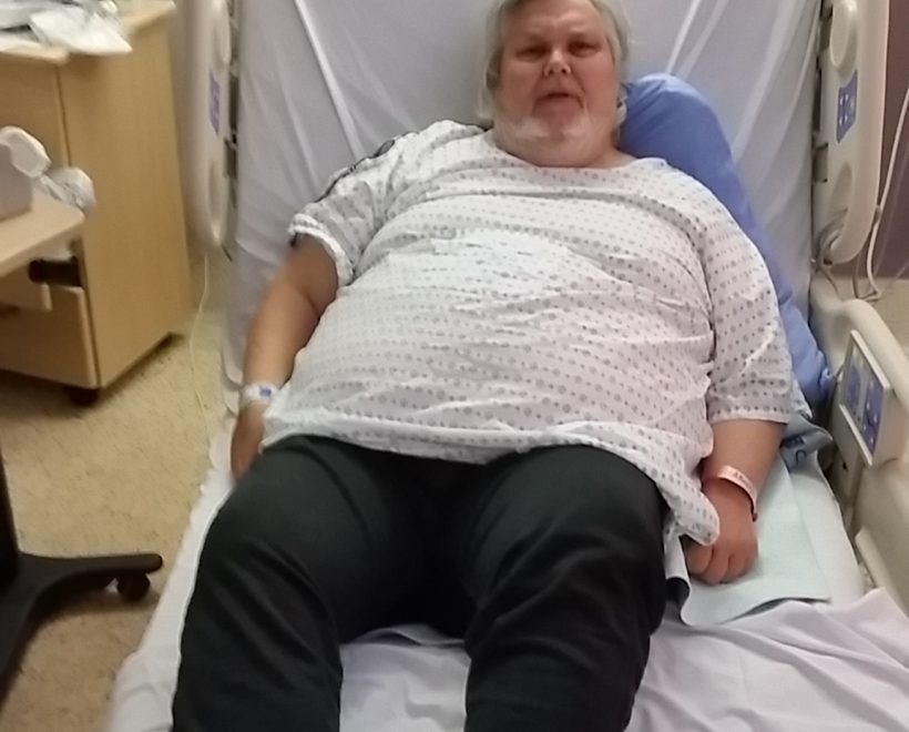 Alan Russell lying in hospital bed