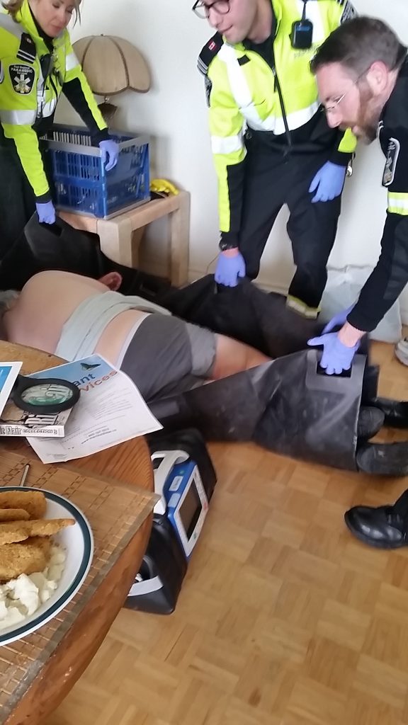 Paramedics rescuing Alan after falling out of wheelchair