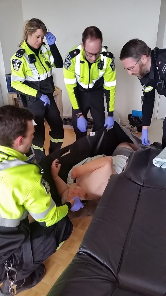 Paramedics rescuing Alan after falling out of wheelchair